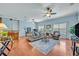 Spacious living room features wood flooring, fan, and comfortable furniture at 466 Ashley Brooke Ct # C, Apopka, FL 32712