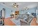 Open living room with wood floors, comfortable seating, and views to the kitchen at 466 Ashley Brooke Ct # C, Apopka, FL 32712