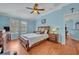 Comfortable main bedroom with wood floors, natural light, and ceiling fan at 466 Ashley Brooke Ct # C, Apopka, FL 32712