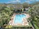 Community swimming pool surrounded by palm trees and lounge chairs at 466 Ashley Brooke Ct # C, Apopka, FL 32712