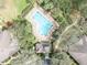 Aerial view of a community swimming pool surrounded by trees, lounge chairs and a gathering area at 466 Ashley Brooke Ct # C, Apopka, FL 32712