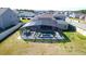 Aerial view of the fenced-in backyard featuring the screened-in pool at 4897 Gilded Jewel Dr, Mount Dora, FL 32757