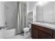 Cozy bathroom featuring a shower-tub combo, toilet, and dark wood vanity at 4897 Gilded Jewel Dr, Mount Dora, FL 32757