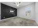 A third bedroom features a ceiling fan and unique chalkboard wall design at 4897 Gilded Jewel Dr, Mount Dora, FL 32757