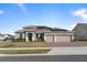 Charming home with three-car garage and a welcoming front entrance, enhanced by professional landscaping at 4897 Gilded Jewel Dr, Mount Dora, FL 32757