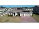 Charming home with solar panels, a brick driveway, and a manicured lawn at 4897 Gilded Jewel Dr, Mount Dora, FL 32757