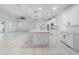 Large kitchen features a spacious island, white cabinetry, and modern appliances at 4897 Gilded Jewel Dr, Mount Dora, FL 32757