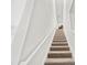 Carpeted staircase with white railing leading to the upper level of the home at 4897 Gilded Jewel Dr, Mount Dora, FL 32757