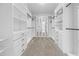 Spacious walk-in closet with custom shelving and drawers for optimal organization at 4897 Gilded Jewel Dr, Mount Dora, FL 32757