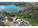 Aerial view of a lakefront residential neighborhood with mature trees at 5136 Stratemeyer Dr, Orlando, FL 32839