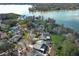 Aerial view of a waterfront home on a lake with mature trees at 5136 Stratemeyer Dr, Orlando, FL 32839