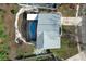 Overhead shot of a house featuring a screened-in pool and patio surrounded by landscaping at 5136 Stratemeyer Dr, Orlando, FL 32839