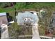 Aerial view of a two-story home with a gray roof and a driveway leading to a garage at 5136 Stratemeyer Dr, Orlando, FL 32839