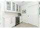 Stylish bar with wine fridge and glass cabinet storage at 5136 Stratemeyer Dr, Orlando, FL 32839