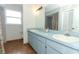 Bathroom featuring double sinks, linoleum floors, vanity, and a shower/tub combo at 5136 Stratemeyer Dr, Orlando, FL 32839