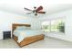 Bright bedroom with a large window, wood-look floors, and a ceiling fan at 5136 Stratemeyer Dr, Orlando, FL 32839