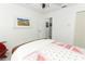 Cozy bedroom featuring white walls, wood-look floors, and a comfortable bed at 5136 Stratemeyer Dr, Orlando, FL 32839