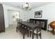 Bright dining room with modern decor, plenty of seating, and access to the kitchen at 5136 Stratemeyer Dr, Orlando, FL 32839