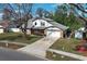 Beautiful two-story home with a brick facade, mature landscaping, and attached garage at 5136 Stratemeyer Dr, Orlando, FL 32839