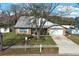 Lovely brick home with a large tree in the front yard and ample parking space at 5136 Stratemeyer Dr, Orlando, FL 32839