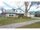 Traditional two-story brick home with a well-manicured front yard and a mature tree at 5136 Stratemeyer Dr, Orlando, FL 32839