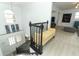 Bright foyer with double doors, staircase with black railings, and view to living room at 5136 Stratemeyer Dr, Orlando, FL 32839