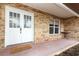 Inviting front porch with double doors, brick accents, and a welcoming doormat at 5136 Stratemeyer Dr, Orlando, FL 32839