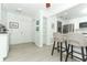 Bright kitchen with stainless steel appliances and bar stool seating open to the living space at 5136 Stratemeyer Dr, Orlando, FL 32839