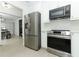 Modern kitchen featuring stainless steel appliances and white cabinetry at 5136 Stratemeyer Dr, Orlando, FL 32839