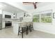 An airy kitchen with stainless steel appliances, island seating, and an abundance of natural light at 5136 Stratemeyer Dr, Orlando, FL 32839