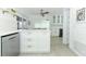 Bright and stylish kitchen featuring stainless steel appliances, an island, and modern white cabinetry at 5136 Stratemeyer Dr, Orlando, FL 32839