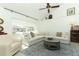 Bright living room with high ceilings, large windows, and stylish furnishings at 5136 Stratemeyer Dr, Orlando, FL 32839