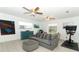 Cozy living room with neutral sofa, accent furniture, ceiling fans, and plenty of natural light at 5136 Stratemeyer Dr, Orlando, FL 32839