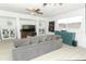 Comfortable living room with light floors, large sofa, TV, and display shelving at 5136 Stratemeyer Dr, Orlando, FL 32839