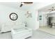 Airy living room featuring an accent mirror and ceiling fan open to the kitchen at 5136 Stratemeyer Dr, Orlando, FL 32839
