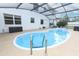 Private backyard pool with a screened enclosure, ideal for enjoying sunny days and outdoor recreation at 5136 Stratemeyer Dr, Orlando, FL 32839