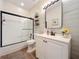 Well-lit bathroom with a shower-tub combo, white vanity, and decorative accents at 777 Crepe Myrtle Cir, Apopka, FL 32712