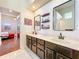 Bathroom with double sink, two mirrors, black fixtures, white tile and view of the main bedroom at 777 Crepe Myrtle Cir, Apopka, FL 32712