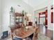 Dining room area with hardwood floors, wooden furniture and view of the entryway at 777 Crepe Myrtle Cir, Apopka, FL 32712