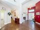 Spacious entryway featuring dark wood floors, a white front door, and an accent wall at 777 Crepe Myrtle Cir, Apopka, FL 32712