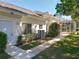 The home's exterior features well-maintained landscaping, a screened lanai and neutral color palette at 777 Crepe Myrtle Cir, Apopka, FL 32712