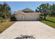 Charming single-story home featuring a three-car garage and manicured landscaping at 777 Crepe Myrtle Cir, Apopka, FL 32712