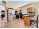 Well-lit kitchen featuring stainless steel appliances, wooden cabinets and mosaic backsplash at 777 Crepe Myrtle Cir, Apopka, FL 32712