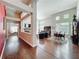 Open-concept living room with hardwood floors, a fireplace, and a view of the backyard at 777 Crepe Myrtle Cir, Apopka, FL 32712