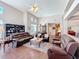 Spacious living room with hardwood floors, comfortable sofas, and natural light at 777 Crepe Myrtle Cir, Apopka, FL 32712
