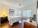 Comfortable bedroom with a ceiling fan, large windows, and wood-look floors at 777 Crepe Myrtle Cir, Apopka, FL 32712