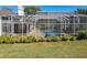View of private pool area with screened enclosure, patio furniture and manicured lawn at 777 Crepe Myrtle Cir, Apopka, FL 32712
