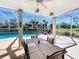 Inviting screened pool area with patio, table, chairs, view to backyard and a beautiful pool at 777 Crepe Myrtle Cir, Apopka, FL 32712