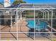 Aerial view of screened pool area with lounge chairs and patio table and chairs at 777 Crepe Myrtle Cir, Apopka, FL 32712