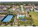 Aerial view of community pool, tennis courts, clubhouse and neighborhood at 8231 Chilton Dr, Orlando, FL 32836